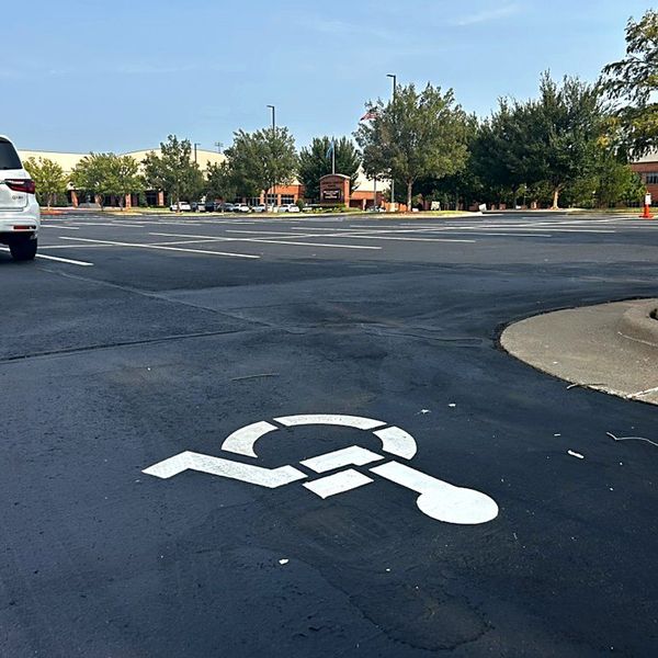 Freshly painted ADA accessible parking symbol on new sealcoat